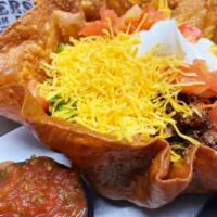 Taco Salad · Fried tortilla shell, lettuce, ground beef, cheddar cheese, tomatoes, sour cream and salsa.