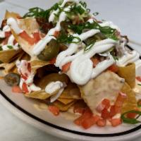 Southern Nachos · Housemade corn tortilla chips, with chipotle queso, pickled jalapenos, roma tomatoes, green ...