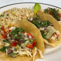Fish Tacos · cajun seared haddock, with cabbage, red pepper and onion mix, avocado crema and cilantro on ...