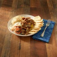 Gyro Plate · Deliciously sliced gyro over basmati rice, onion, tomato, humus and pita.