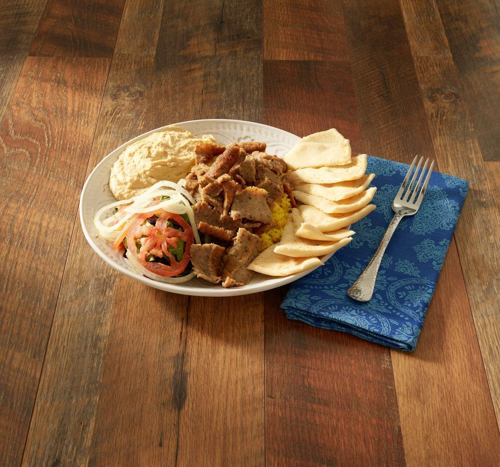 Gyro Plate · Deliciously sliced gyro over basmati rice, onion, tomato, humus and pita.