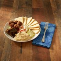 Veggie Delight · Falafel and dolmas served over a bed of lettuce, with hummus, Arab pickles, tomatoes, and on...