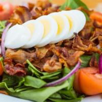 Tina's Spinach Salad · Fresh spinach, bacon, tomatoes, red onions and a sliced hard boiled egg.