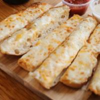 Cheesy Breadsticks · Baked bread that has been flavored with cheese.