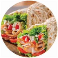 Turkey Pesto Wrap · Turkey breast roasted red peppers crumbled feta cheese, green leaf lettuce, and basil with c...