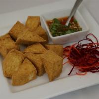 Organic Fried Tofu · 12 pieces. Non-breaded organic fried tofu served with sweet chili sauce topped with crushed ...