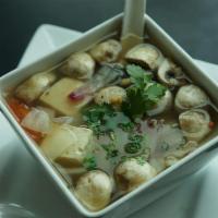 Tom Yum · Traditional Thai herbal hot and sour soup with mushroom, tomato, and red onion, topped with ...