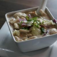 Tom Kha · Creamy Thai herbal hot and sour coconut soup with cabbage, mushroom, red onion, topped with ...