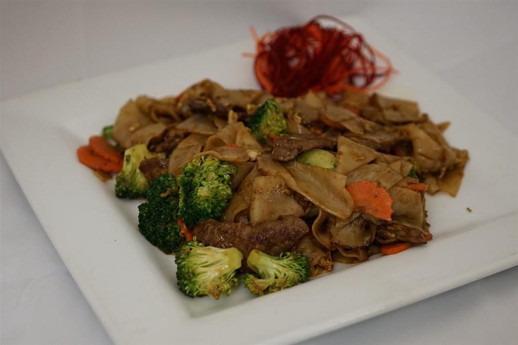 Pad See Ewe · Stir-fried wide rice noodles with egg, broccoli, and carrot in Thai sweet soy sauce. Vegetarian option available.