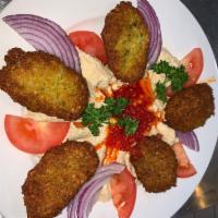 Falafel · Mashed chickpeas with celery, parsley, onions, garlic and herbs, served with tahini sauce.