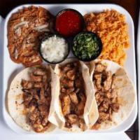 Tacos de Pollo Azado · 3 pieces. Tender grilled chicken breast on choice tortillas: complimented with Spanish rice,...