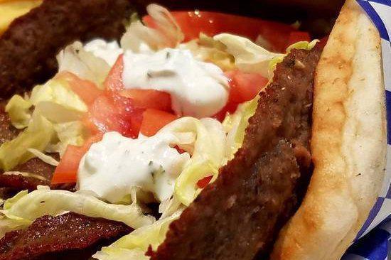 Lamb Gyro · Greek style seasoned lamb cooked on a spit and wrapped in a pita with lettuce, tomato, and a side of tzatziki sauce. 