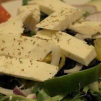 Side Greek Salad (V) · Mixed greens, cucumbers, tomatoes, peppers, onions, olives, and feta cheese