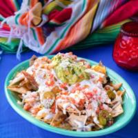 Nachos · Crispy chips, melted cheese, pickled jalapenos, black beans, sour cream and guacamole.