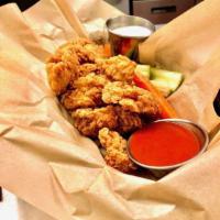 Boneless Wings · White breast meat battered and fried in your choice of sauce. Served with carrots, celery, a...