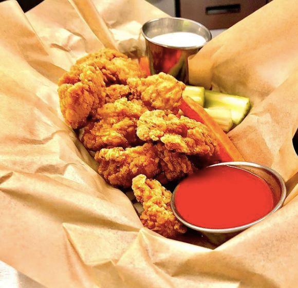 Chicken Strips Basket · Served w/fries or sub Onion rings*
Breaded chicken breast fried to golden perfection, served with fries and ranch. Tossed in sauce of your choice.