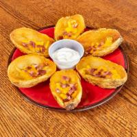 Potato Skins · Six pieces. Cheddar cheese and sour cream with bacon bits.