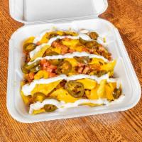 Nachos Supreme · Corn chips, taco beef, sour cream, cheese, tomato and jalapenos with salsa. 