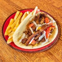Gyro Sandwich · Lamb meat, tomatoes, onions in a pita bread with tzatziki sauce.  Served with french fries.