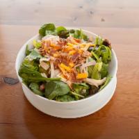 WuShock · Mixed greens, romaine, ham, turkey, bacon, diced red onions & cheddar jack cheese, tossed wi...