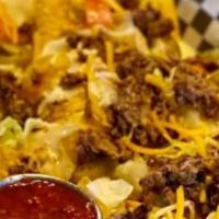 Steak Nachos · Topped with lettuce, tomatoes, cheddar Jack cheese and queso. Served with jalapenos, salsa a...
