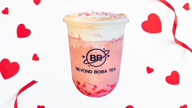 Love Potion · Classic black tea blended with non-dairy creamer, flavorful strawberry jam, chewy strawberry heart jellies, cheese foam, and festive sprinkles