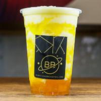 Mango Coconut Smoothie · Creamy mango flavor ice-blend with coconut milk and layered over mango jam and mango walls