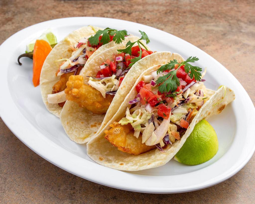 Fish Taco · fresh deep fired fish in house made beer batter, blackened jalapeno mayo coleslaw (not Spicy), pico de gallo, guacamole, with The Special Paco's Tacos fish sauce on a flour tortilla