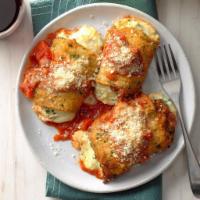 Eggplant Rollatini · 3 pieces of fried eggplant, rolled with seasoned ricotta and Romano cheese, topped with sauc...