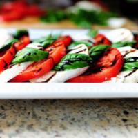 Mozzarella Caprese Appetizer  · Layered fresh mozzarella, tomato, roasted red peppers and basil with balsamic glaze. 