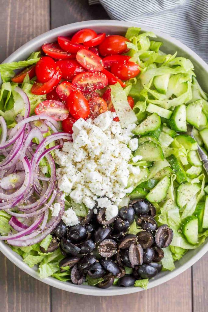 Greek Salad · Iceberg or romaine lettuce, feta cheese, tomatoes, cucumbers, roasted red peppers, red onions, Kalamata olives, served with house Greek dressing.