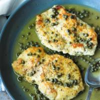 Veal Piccata · Tender pan seared veal sautéed with capers and artichoke hearts in a light wine lemon sauce.