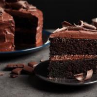 Chocolate Cake · Triple-layer chocolate cake slice.