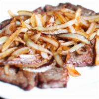 Bistec Encebollado · Steak with onions, rice and beans.