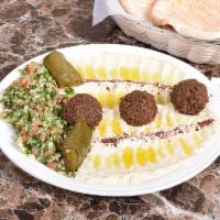 Middle Eastern Platter · A medley of hummus, baba ghanoush, falafel pieces and served with our authentic tabouleh sal...