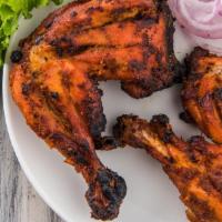 Chicken Tandoori · Flavorful chicken drumsticks marinated and cooked in a traditional clay oven and served with...