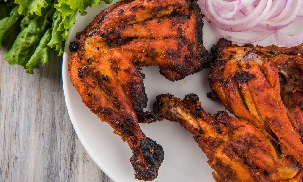 Chicken Tandoori · Flavorful chicken drumsticks marinated and cooked in a traditional clay oven and served with a side of basmati rice. Gluten free.