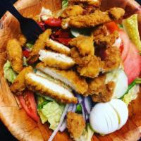 Chicken Finger Salad · Made with mixed greens, red onions, cucumbers, tomatoes, Kalamata olives, peppers and hard b...
