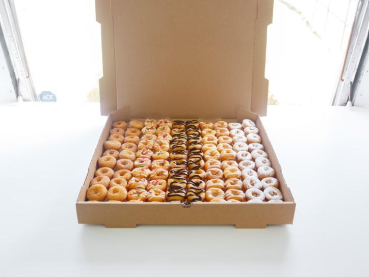 Box of 100 TLD · What a sweet deal! A customized box of 100 tiny little donuts. Choose any of our flavors for this fun box that is perfect for events, meetings and an over the top gift! Create your own box with sprinkles, glazes and toppings. 