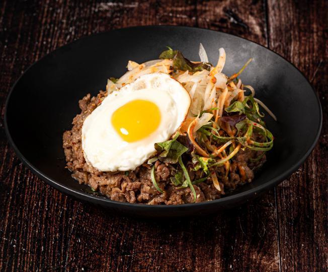 Raging Bulgogi · Rice with creamy rib eye, lettuce, egg, soy sauce, perilla leaves, and onion crisp, .