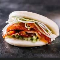 #2. Peking Duck Bun · Chinese roasted crispy duck served with scallion, cucumber, and house sauce.