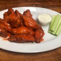 Buffalo Wings · Cooked wing of a chicken coated in mild, spicy, BBQ sauce, or plain.