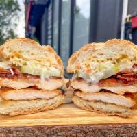 52. Tommy Blue Eyes  · Chicken, melted Swiss, bacon, bread and butter pickles, slaw, honey mustard.
