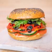 63. Hummus Delight · Hummus, cucumber, roasted peppers, tomato, black olives, arugula, balsamic glaze