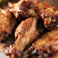 Chicken Wings · Cooked wing of a chicken coated in sauce or seasoning.