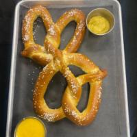 Hot Pretzel · 2 fresh baked salted pretzels served with queso and spicy brown mustard.
