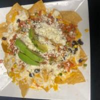 La Veggie Nachos · Topped with queso, black beans, roasted corn, sliced avocado, and fresh pico de gallo.