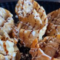 Gooey S'mores Wontons · Chocolate cheesecake and marsh mellows on the inside, with marsh mellow, chocolate drizzle a...