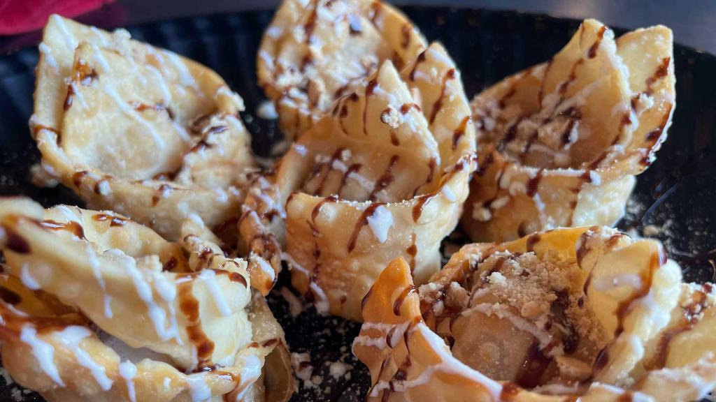 Gooey S'mores Wontons · Chocolate cheesecake and marsh mellows on the inside, with marsh mellow, chocolate drizzle and crushed graham crackers on top!