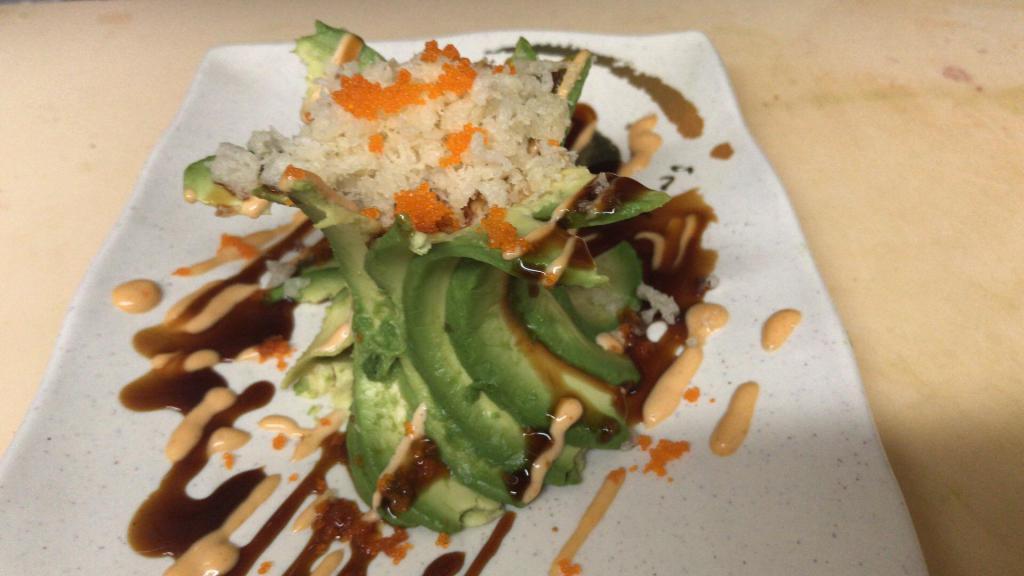 Spicy Volcano Salad · Inside: Spicy Kani. Outside: Wrapped with Avocado and Masago, Eel sauce, Spicy Mayo sauce on the top.
